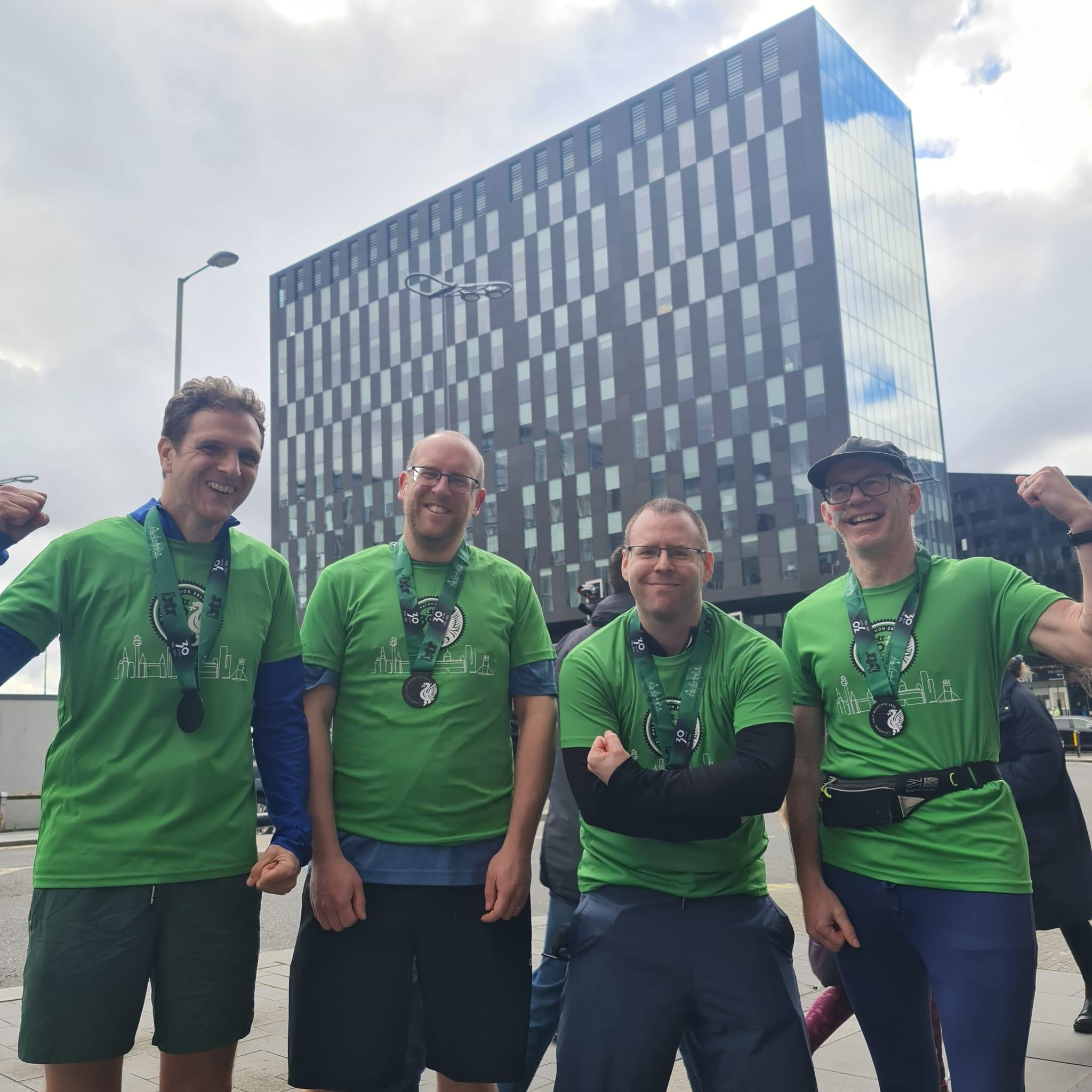 4 crowder employees with their medals after completing the half marathon
