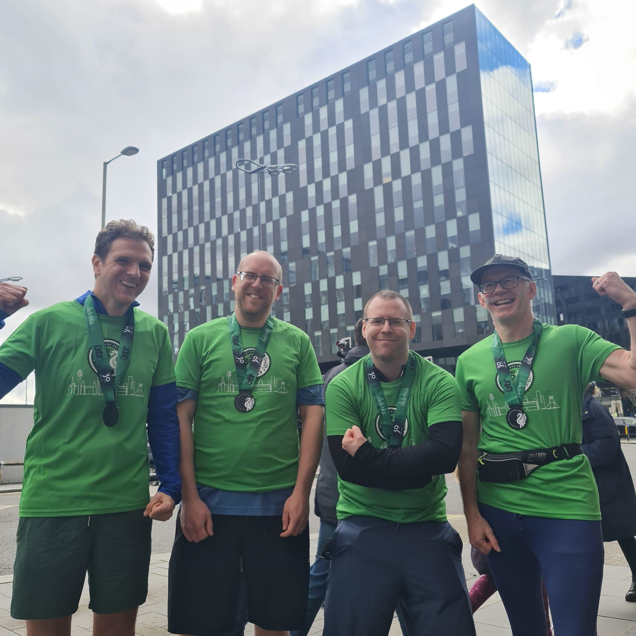 4 crowder employees with their medals after completing the half marathon 